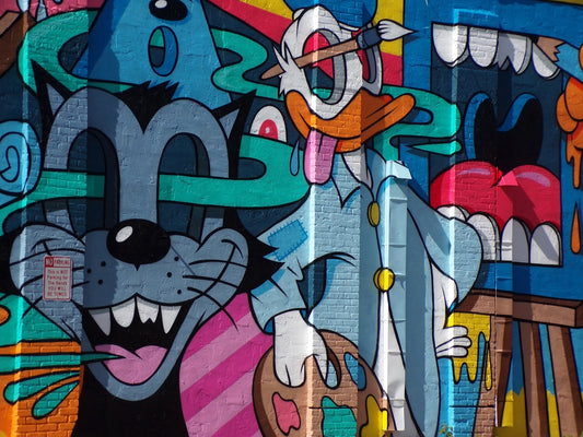 a mural of a cat and a mouse on a building