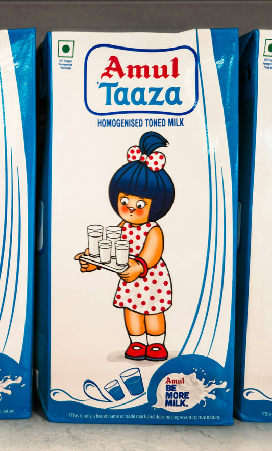 Amul taaza milk carton with a girl holding glasses