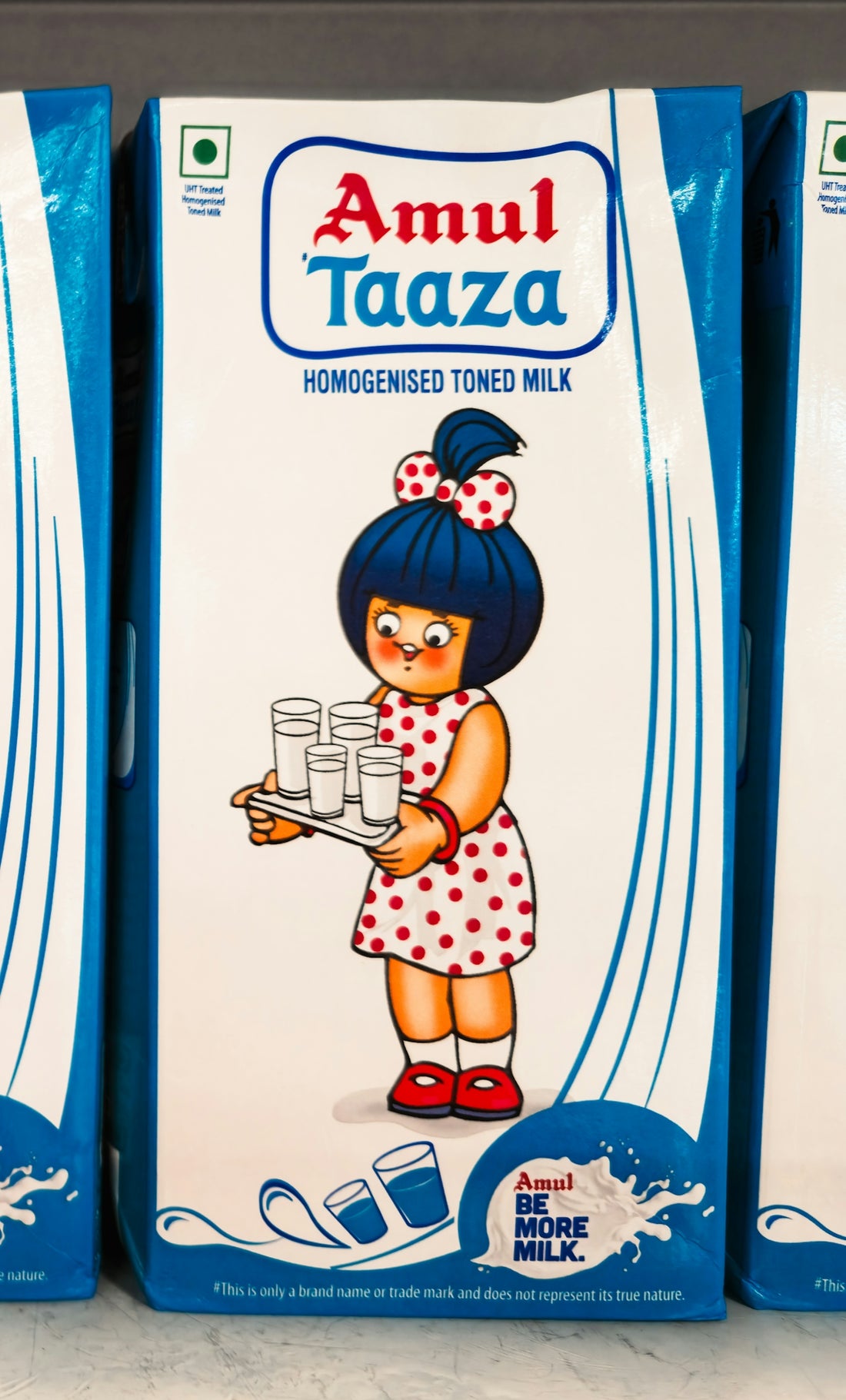 Amul taaza milk carton with a girl holding glasses